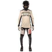 Cream long-sleeve cycling jersey with Fasthouse Speed Shop logo on front