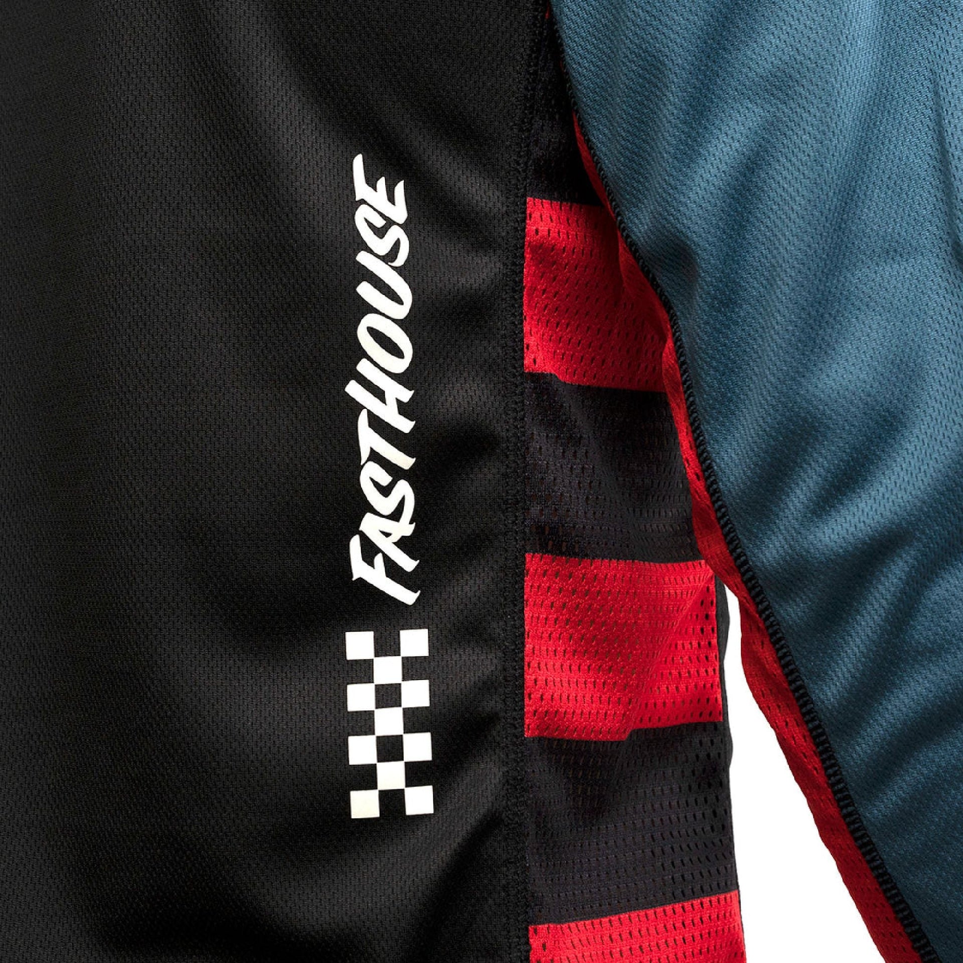 Side detail of long-sleeve jersey sleeve with white check logo and red mesh panel