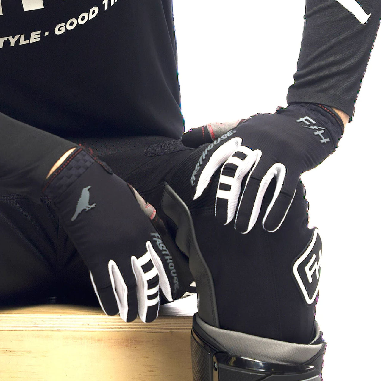 Black motocross air glove with white branding, padded knuckles, and wrist strap