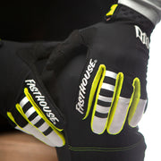 Youth motocross glove close view, black with white stripes and neon yellow finger accents