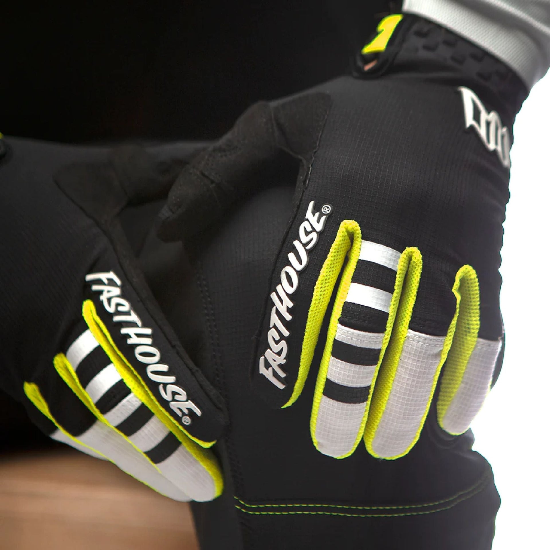 Youth motocross glove close view, black with white stripes and neon yellow finger accents