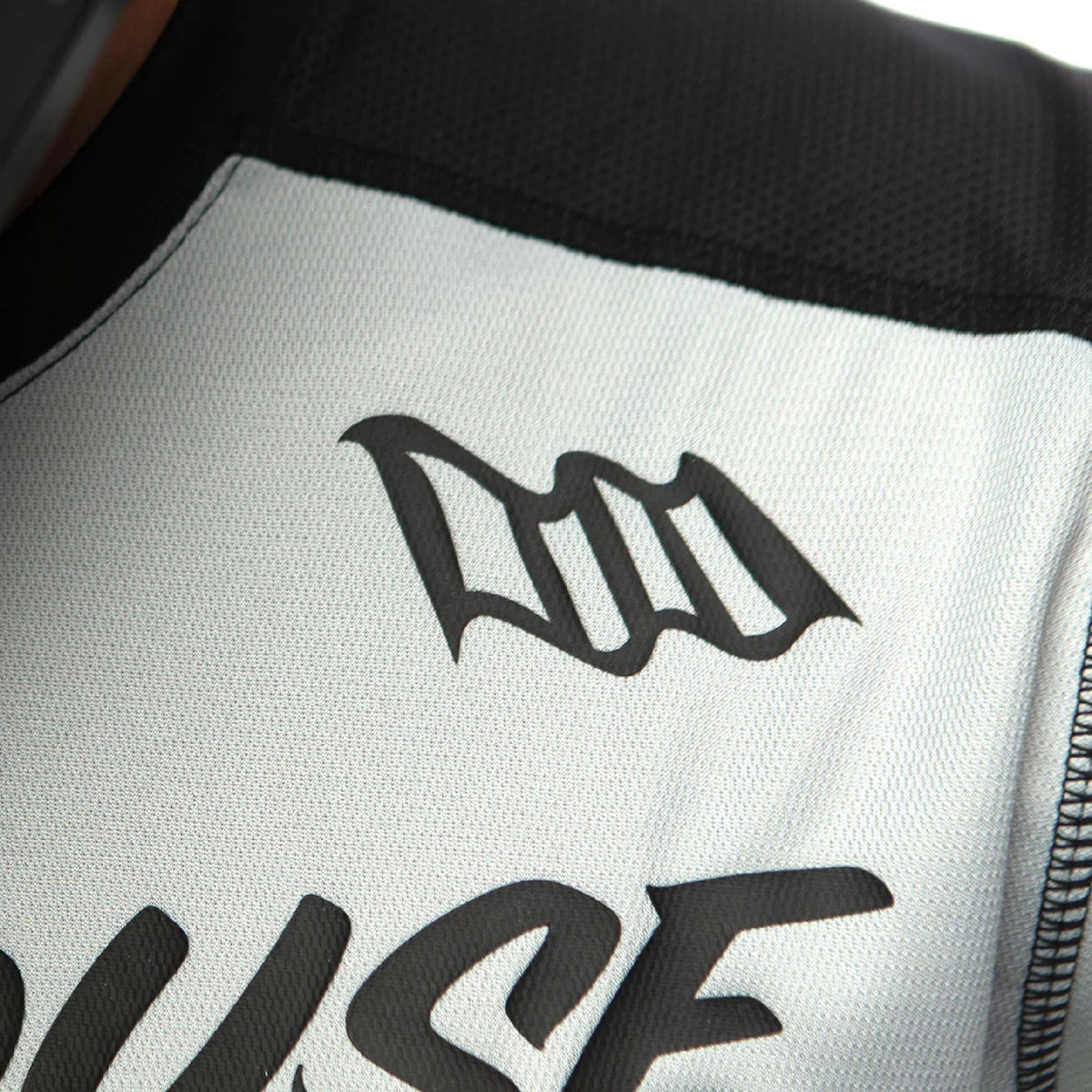 White jersey panel with large black 'Fasthouse' logo.