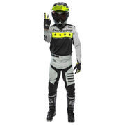 Rider model wearing black-and-white jersey with long sleeves and neon yellow star band.