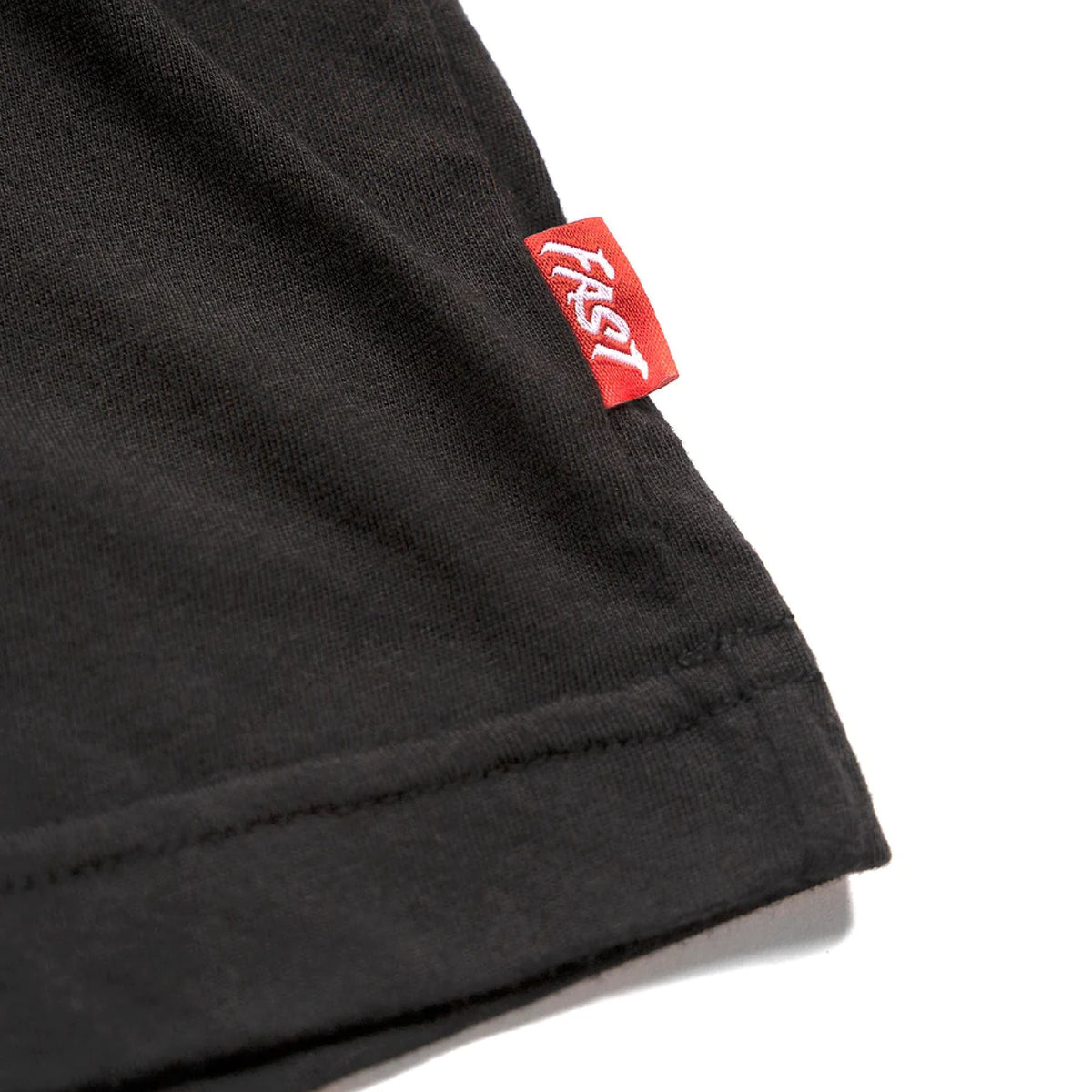 Dark gray tech tee hem close-up with red brand tag