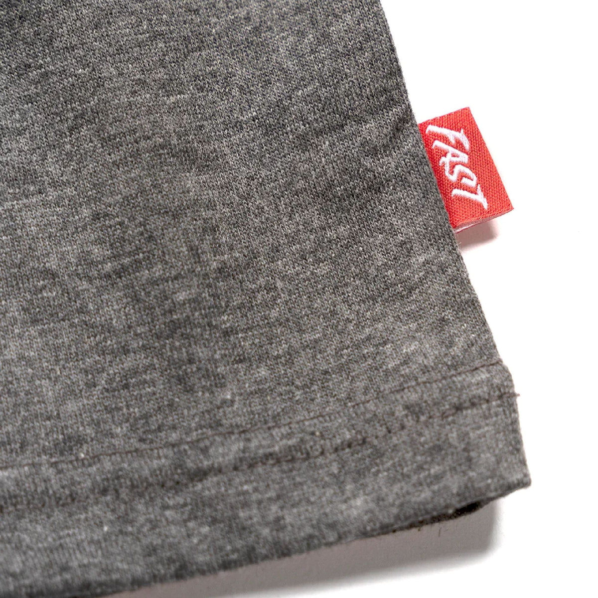 Heather gray tech tee cuff close-up with red brand tag