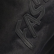 Fasthouse Growler pant fabric close-up, black with stitched logo panel detail