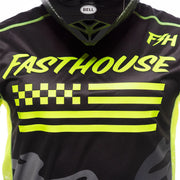 Fasthouse riot jersey close-up: neon “Fasthouse” logo, checkered and stripe graphics