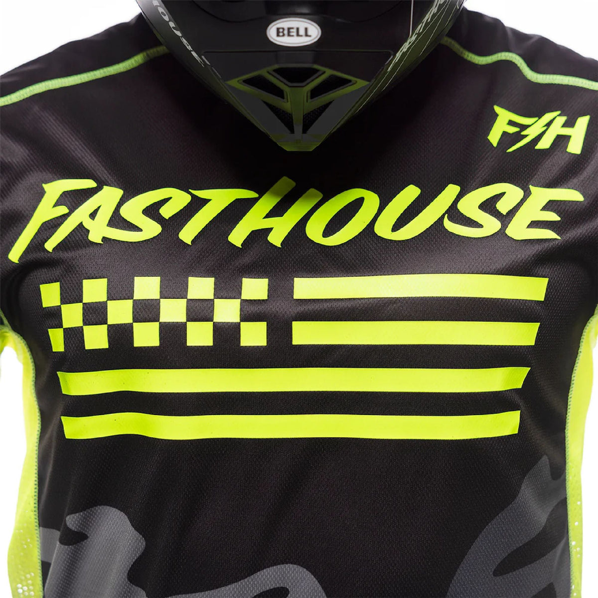Fasthouse riot jersey close-up: neon “Fasthouse” logo, checkered and stripe graphics