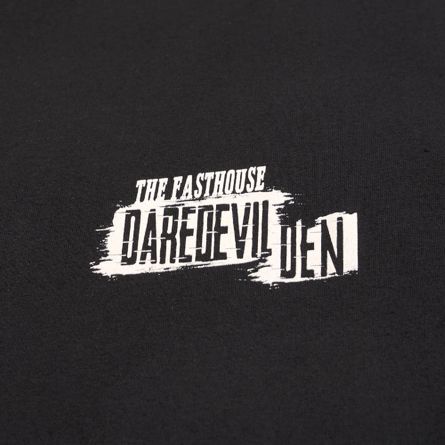 Black T-shirt close-up of distressed "Daredevil" logo print
