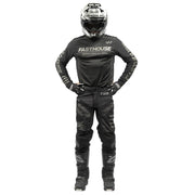 Black off-road long-sleeve jersey with FASTHOUSE chest logo, worn with riding gear