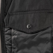 Black puffer vest with snap-flap chest pocket and quilted front panel