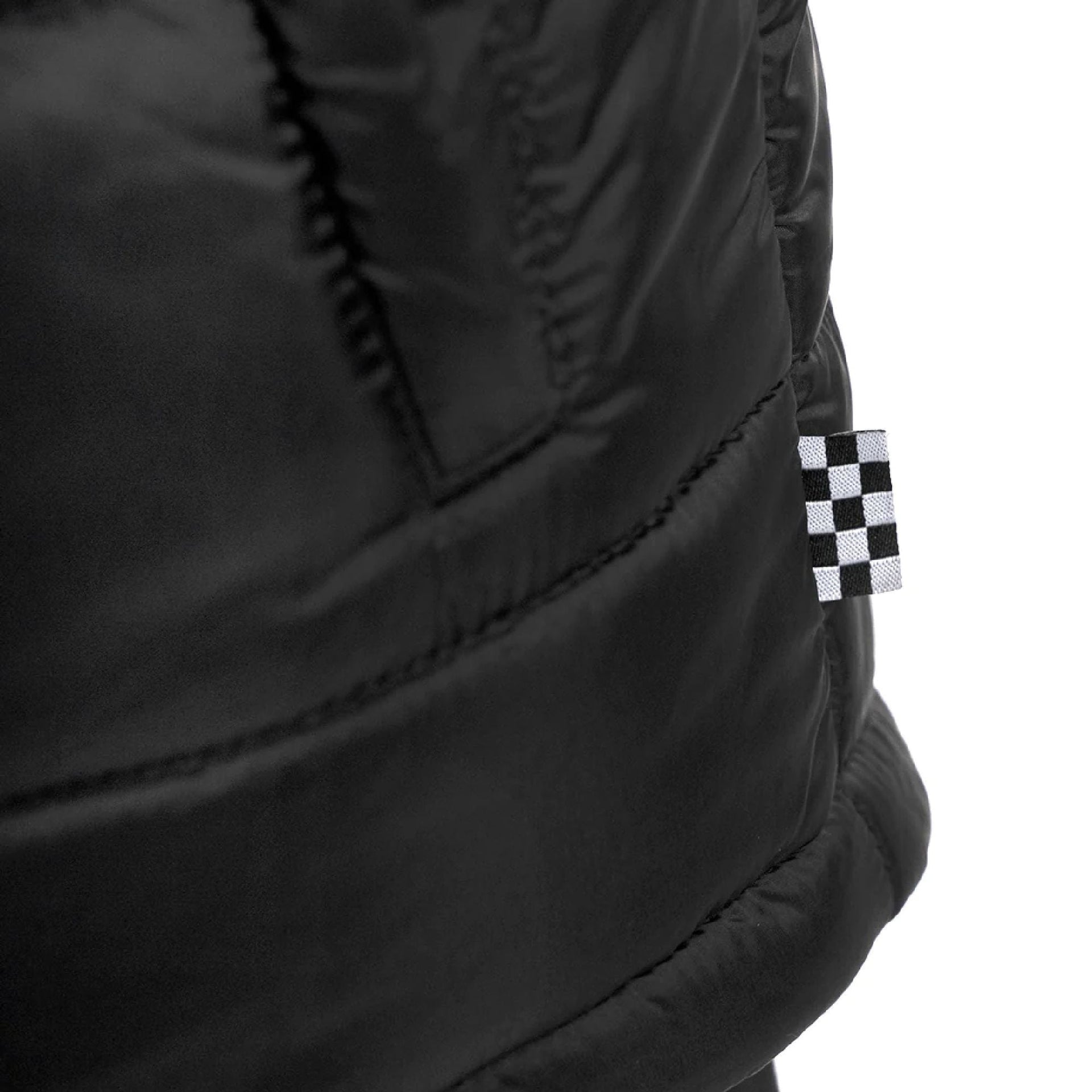 Black quilted puffer vest with checker patch detail on the side