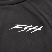 Close-up of white Fasthouse logo on black Fasthouse Rush raglan tech tee fabric