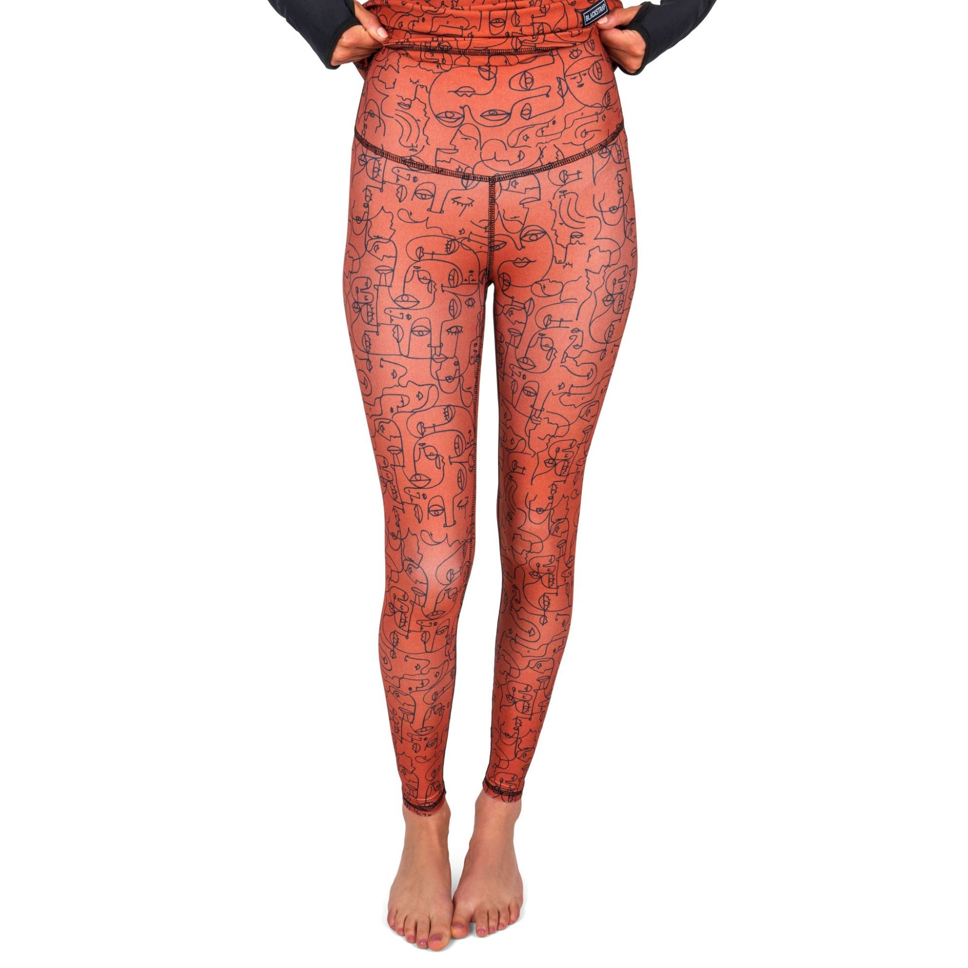 Burnt orange line-art face print base layer leggings with slim ankle-length fit