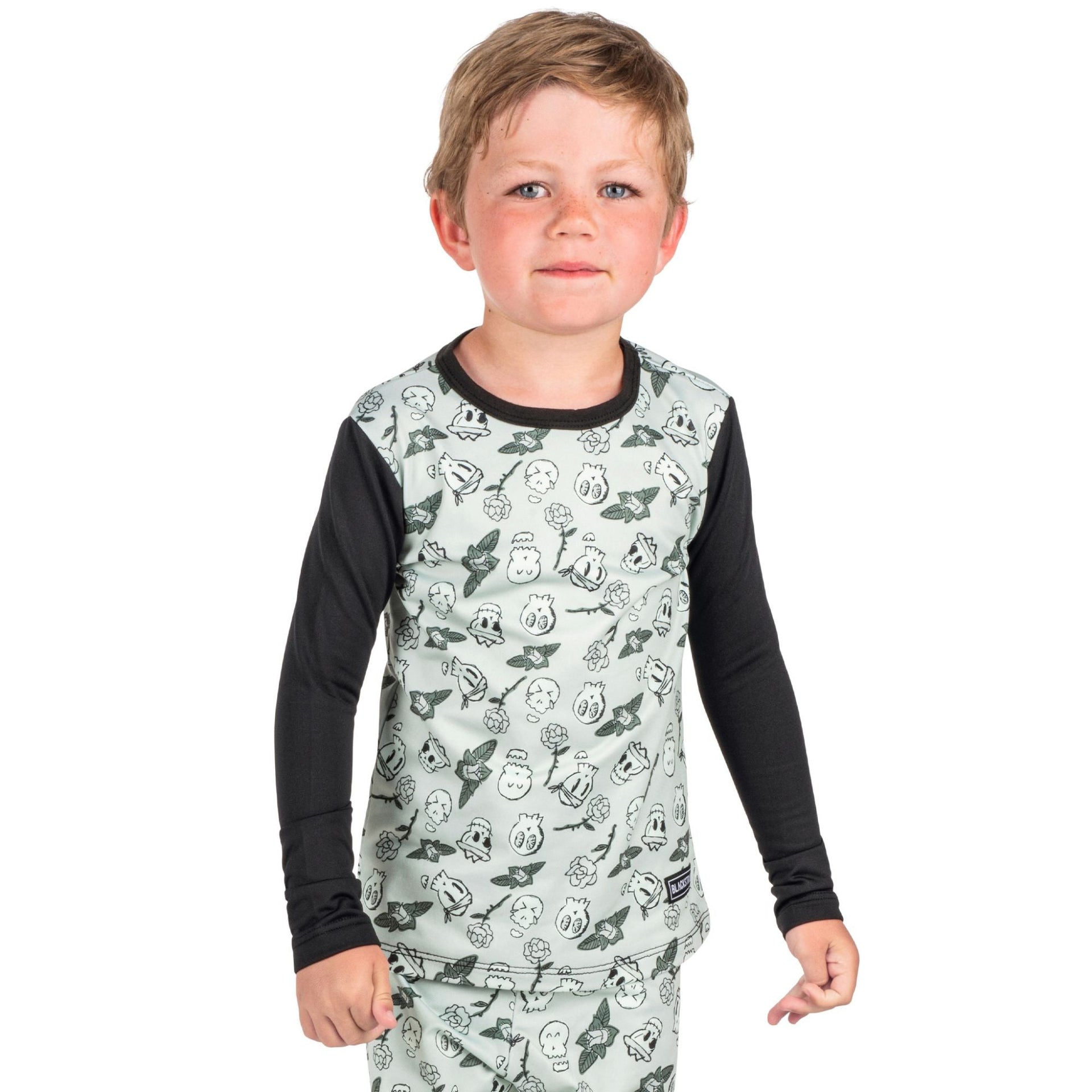 Youth therma baselayer top with light gray animal-face print and black long sleeves