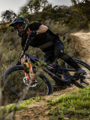 Black bike pants on a cyclist riding a mountain bike