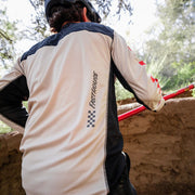 Cream long-sleeve cycling jersey back with black panels and red check accents