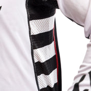 Motorcycle jersey side panel detail with white and black mesh stripes and red trim seam.