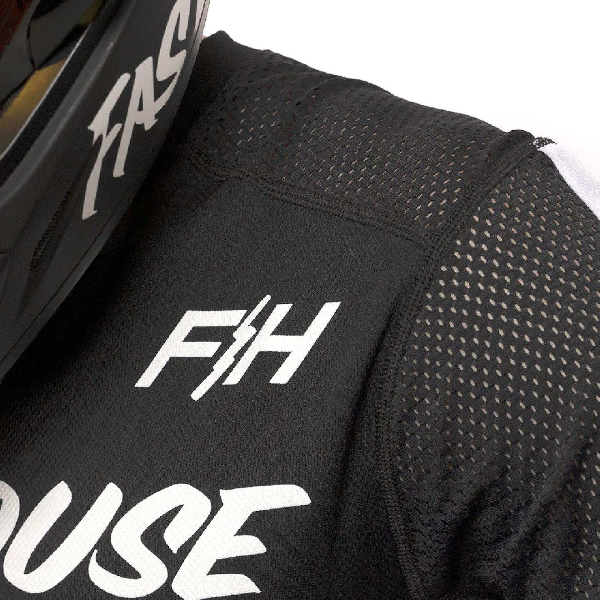 Black jersey close-up with F/H logo and perforated air-cool fabric texture