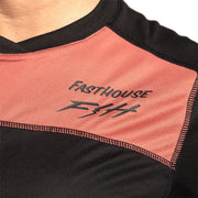 Women's riding jersey close-up, FastHouse logo on orange-mauve chest panel