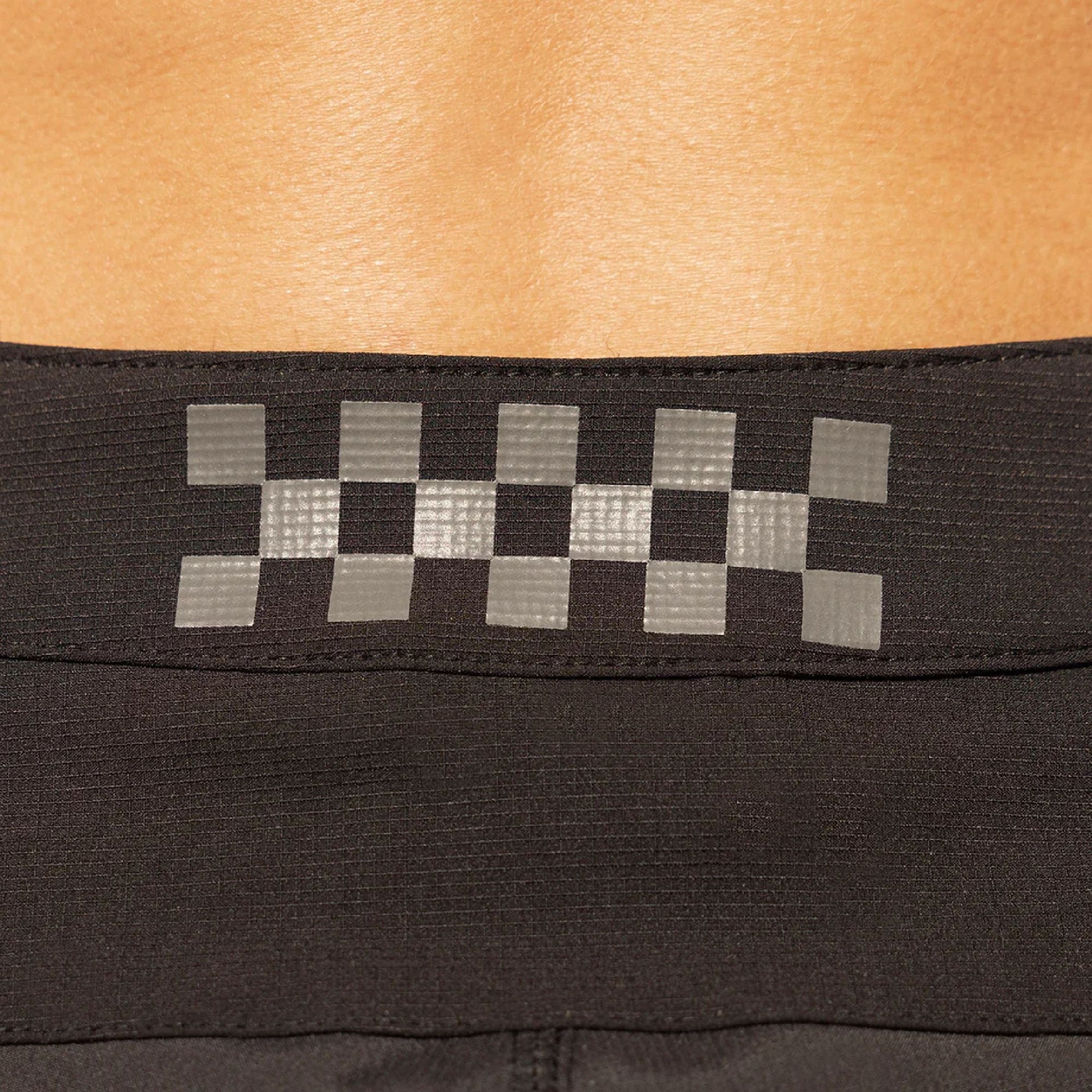 Fasthouse checkered logo waistband on black riding shorts