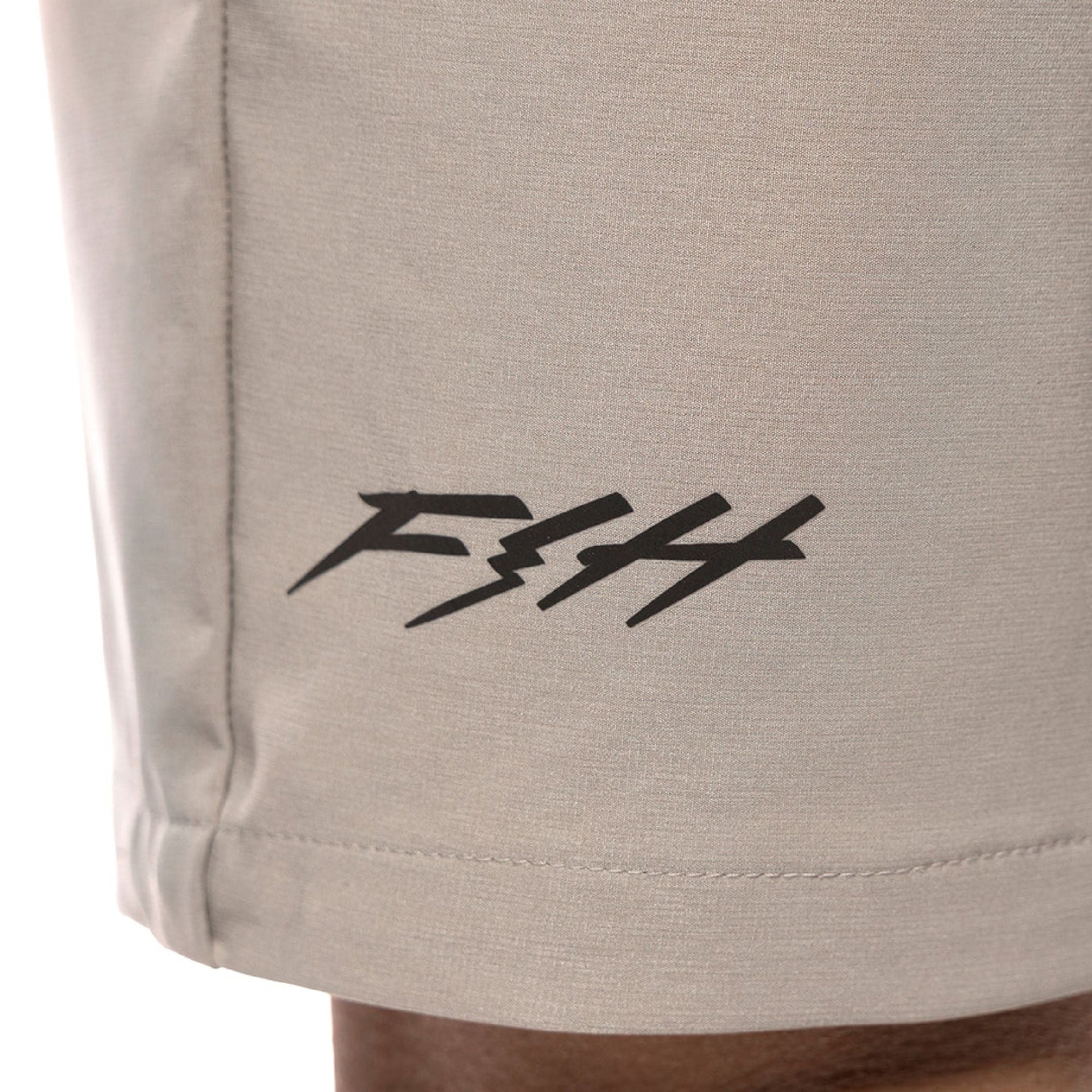 Ash gray shorts with black Fasthouse Speed Shop logo on the leg