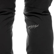 Black riding pants close-up with Fasthouse logo on thigh