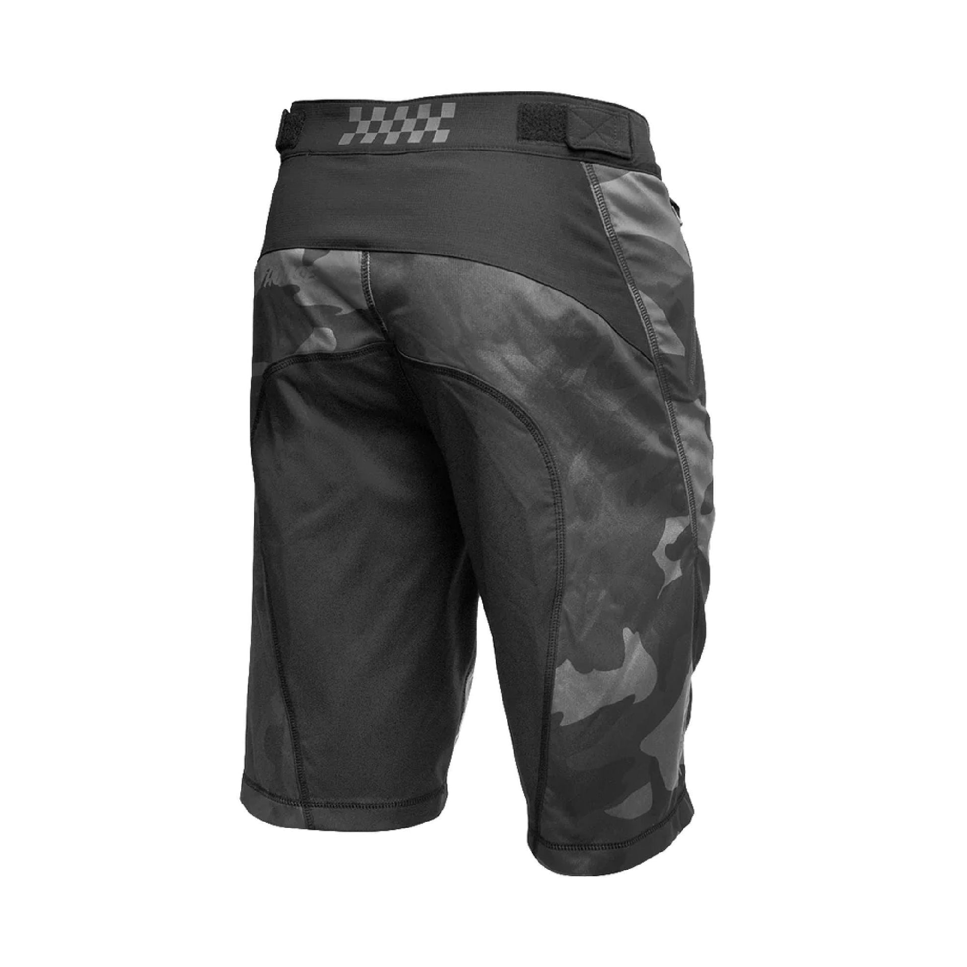 Youth black camo riding shorts with checkered waistband and side zip pocket.