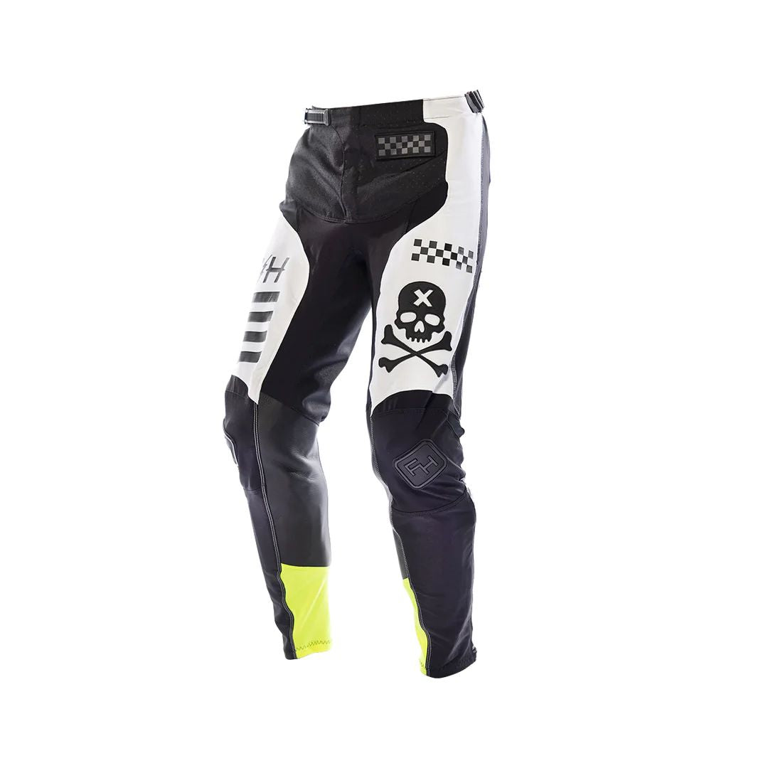 Youth riding pants in black with white graphics, skull patch, neon yellow accents