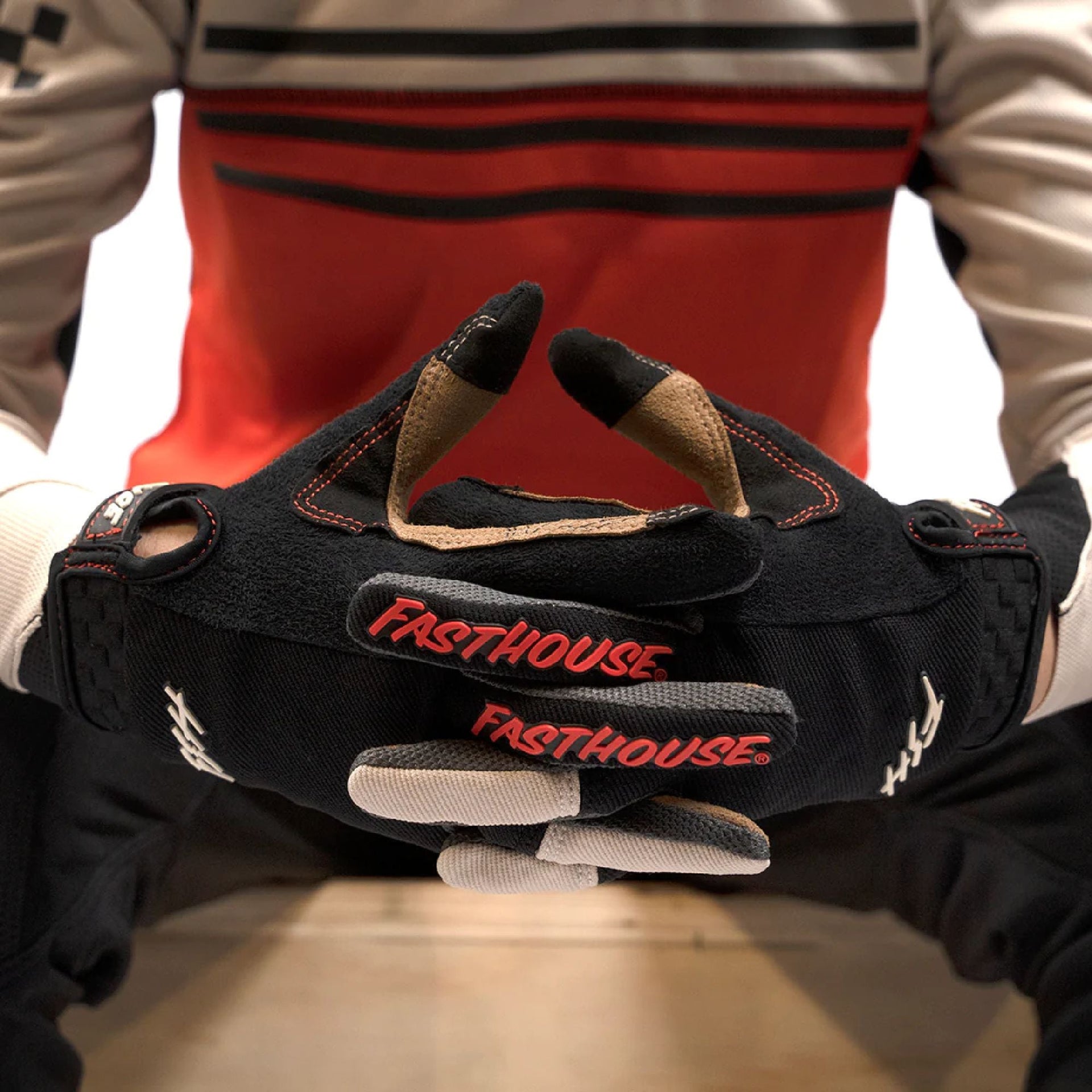 Black youth riding glove with red Fasthouse logo and contrast thumb padding