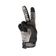 Youth riding gloves in black with light gray palm and Fasthouse logo on wrist