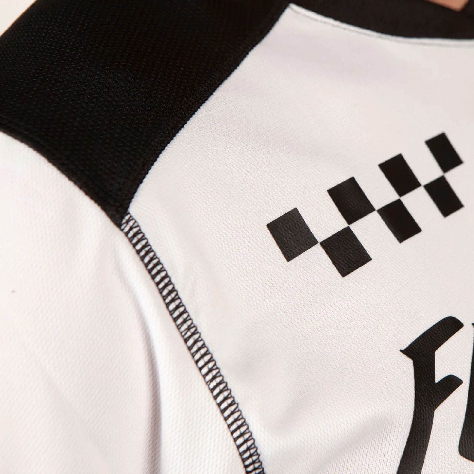 White-and-black jersey sleeve with checkered graphic and stitched trim