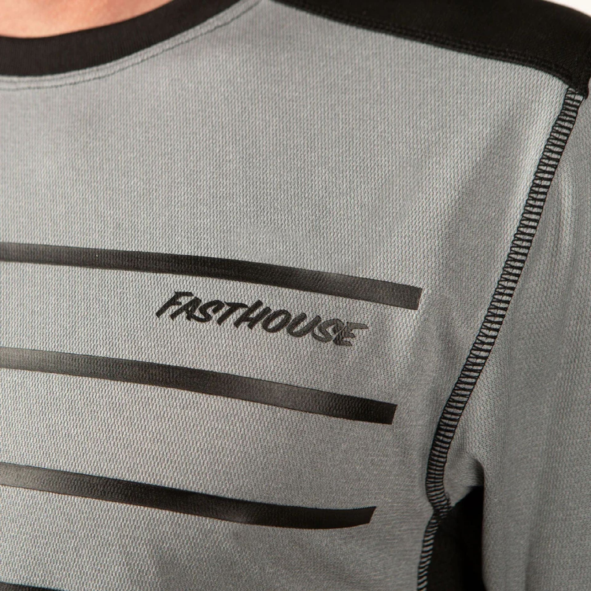 Men's heather grey jersey chest with white stripe graphics and FastHouse logo text.