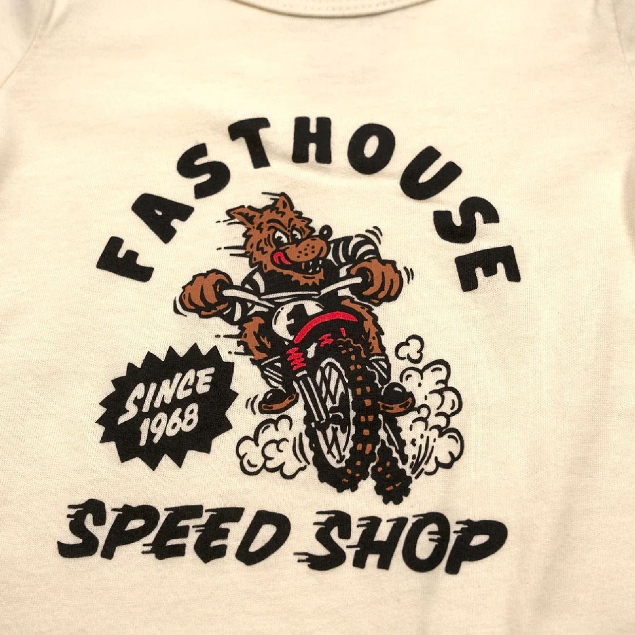Infant natural onesie close-up of Speed Shop front rider graphic