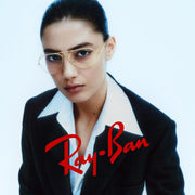 Woman wearing gold prescription eyewear frames with dark demo lenses