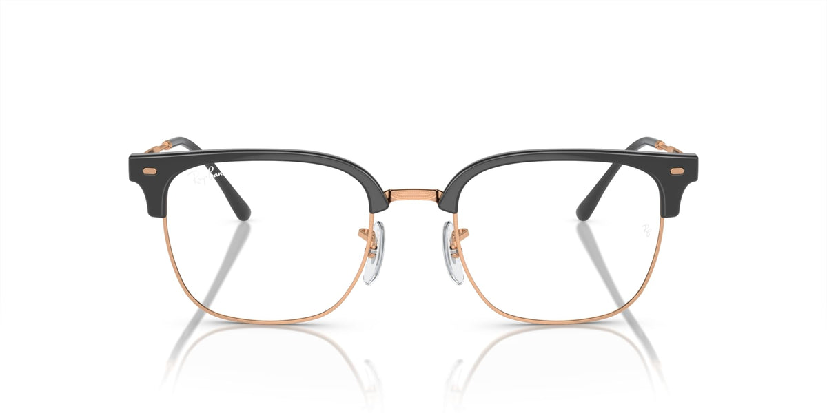 Prescription eyeglass frames in black with rose-gold accents and clear lenses
