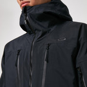 Black shell jacket close-up of hood drawcord, front zip, and chest zip pockets