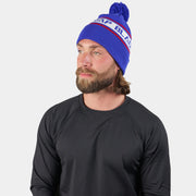 Cold-weather beanie with pom, royal blue knit worn by a model