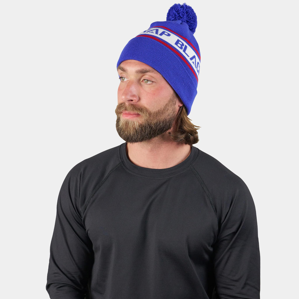 Cold-weather beanie with pom, royal blue knit worn by a model