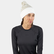 Cold-weather beanie with pom, white knit worn by a model