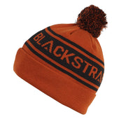 Burnt orange pom beanie with black logo stripe and textured cuff