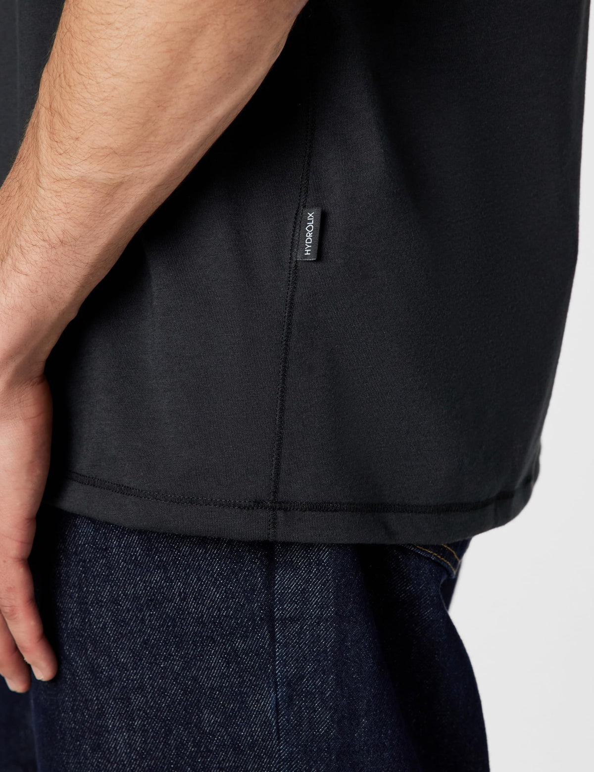 Black crew-neck T-shirt with brand label at the side seam near hem.