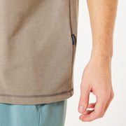 Beige crew-neck T-shirt with small brand tag near side seam and hem.